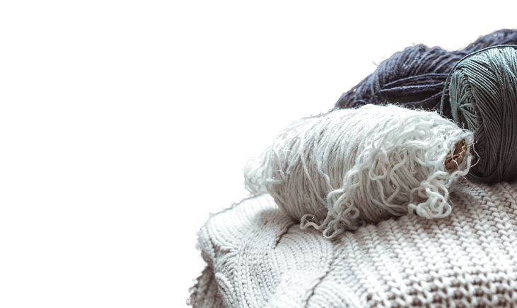 knitted sweater with balls of yarn ,a concept of warmth and comfort, hobby , background,closeup