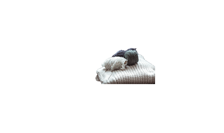 knitted sweater with balls of yarn ,a concept of warmth and comfort, hobby , background,closeup